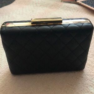 A black with gold detailing clutch